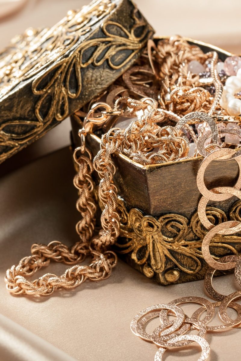 Jewelry and other decorations in decorative box heart shape on the silk fabric